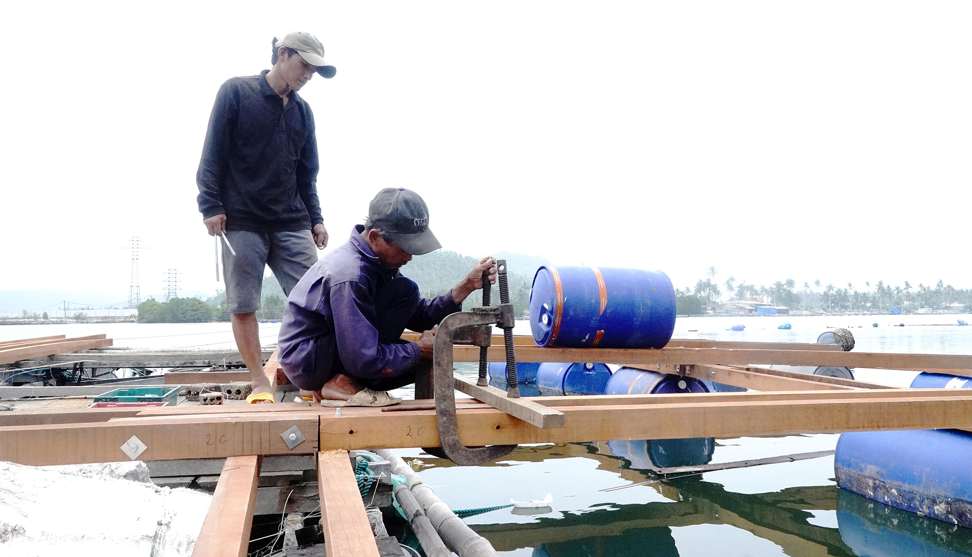 Người nu&ocirc;i trồng thủy hải sản ở đầm C&ugrave; M&ocirc;ng (tỉnh Đắk Lắk) sử dụng gỗ để đ&oacute;ng c&aacute;c b&egrave; nu&ocirc;i c&aacute; với phương thức truyền thống, nhiều rủi ro.